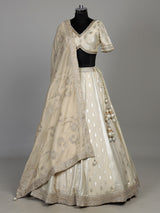Cream banarasi silk lehenga choli with intricate zardosi embellishments