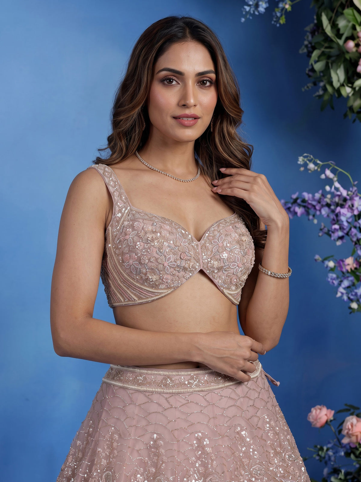 Light pink net lehenga choli with cutdana and sequin embellishments