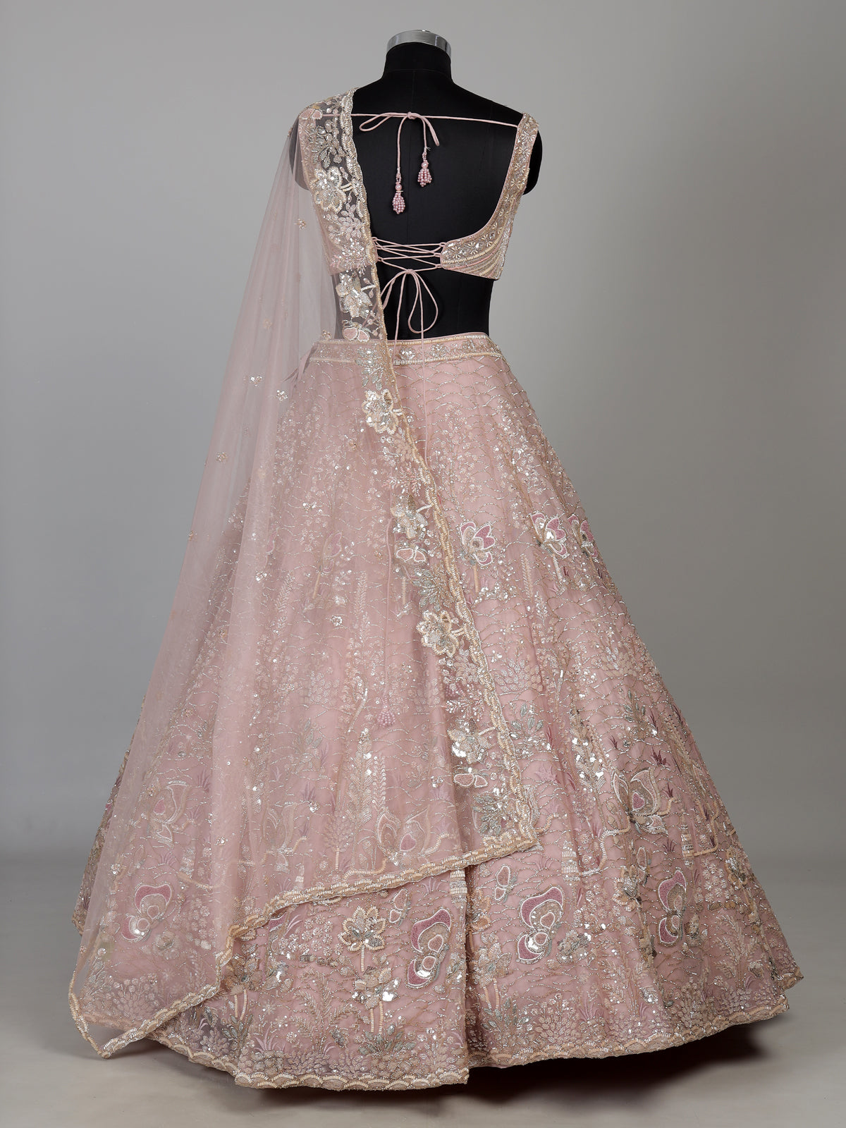 Light pink net lehenga choli with cutdana and sequin embellishments