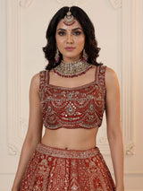 Rust orange silk lehenga choli with mirror and zardosi work