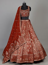 Rust orange silk lehenga choli with mirror and zardosi work