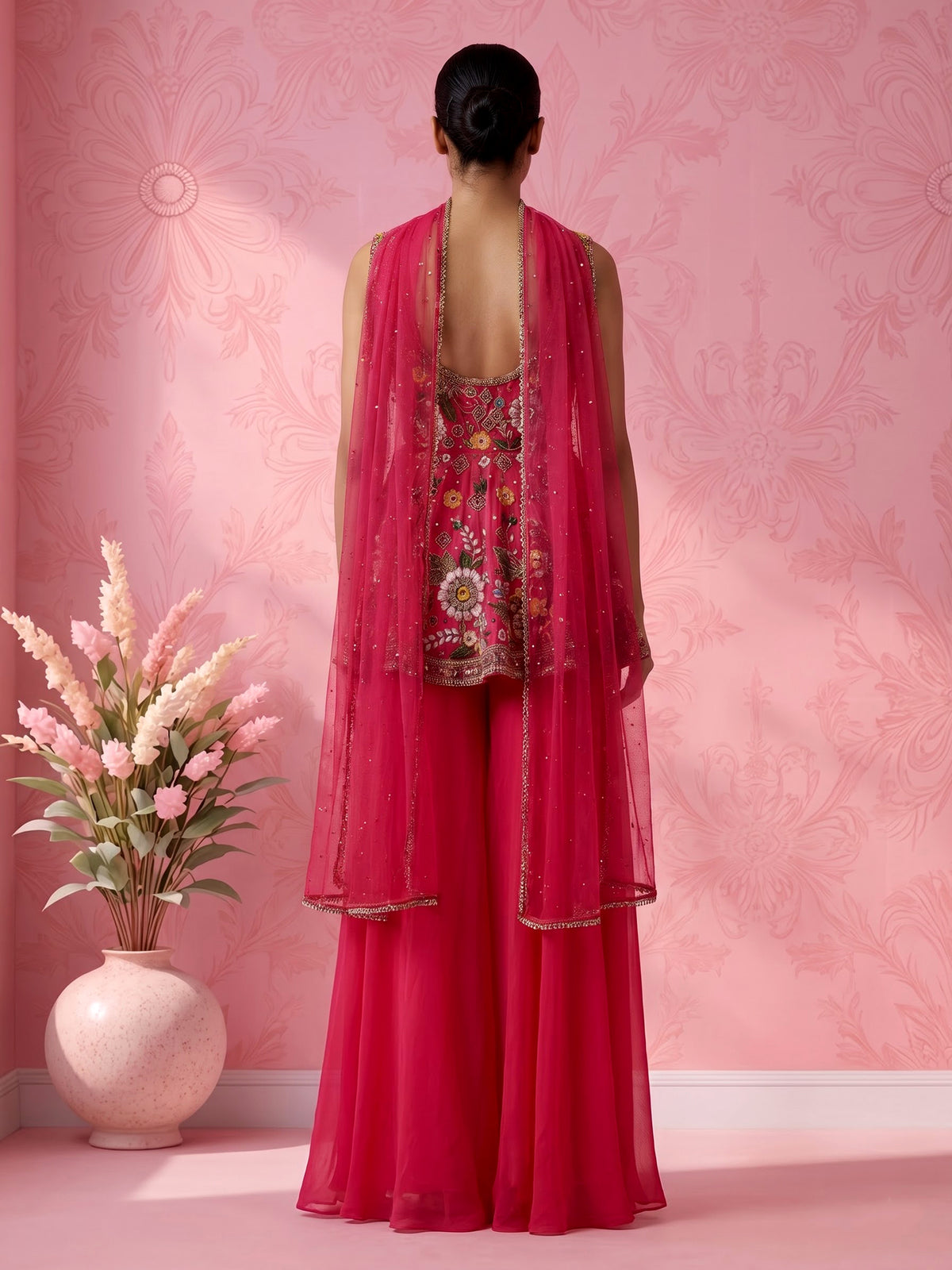 Rani pink silk palazzo suit with mirror work and net dupatta