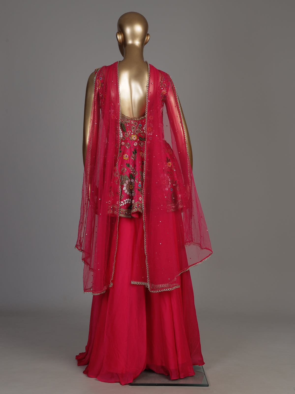 Rani pink silk palazzo suit with mirror work and net dupatta