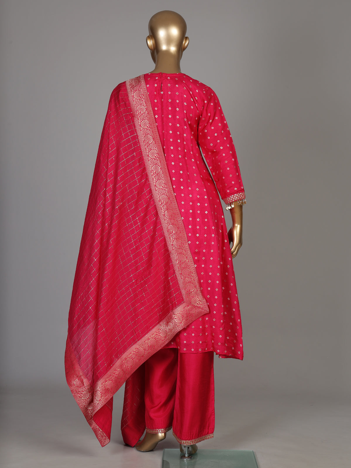 Rani pink silk bandhani suit with an embellished yoke