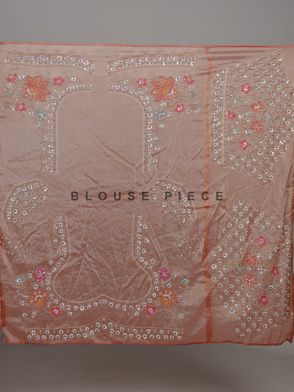 Pastel peach tissue silk saree with floral cutdana and tassels