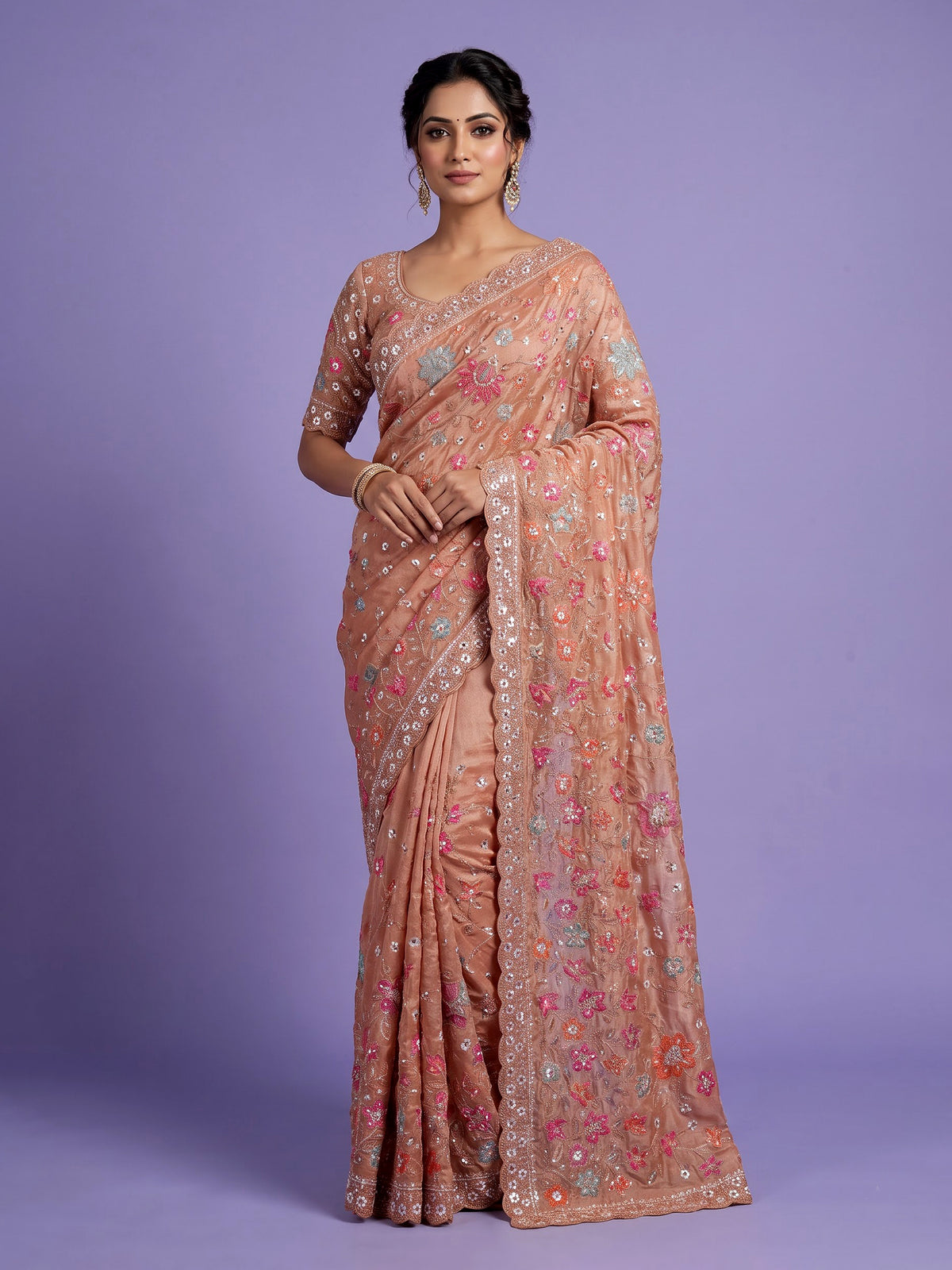 Pastel peach tissue silk saree with floral cutdana and tassels
