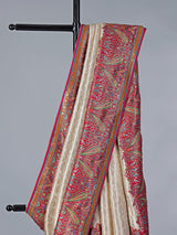 Cream tissue silk saree with colorful motifs embellishments