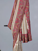 Cream tissue silk saree with colorful motifs embellishments
