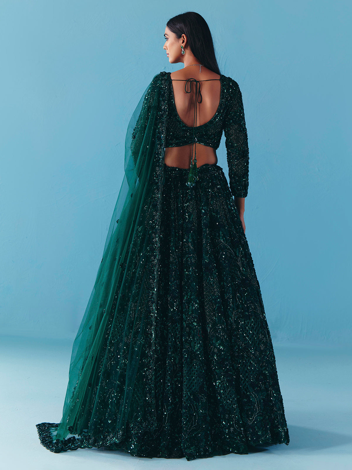 Dark green net lehenga choli with stone and sequins detail