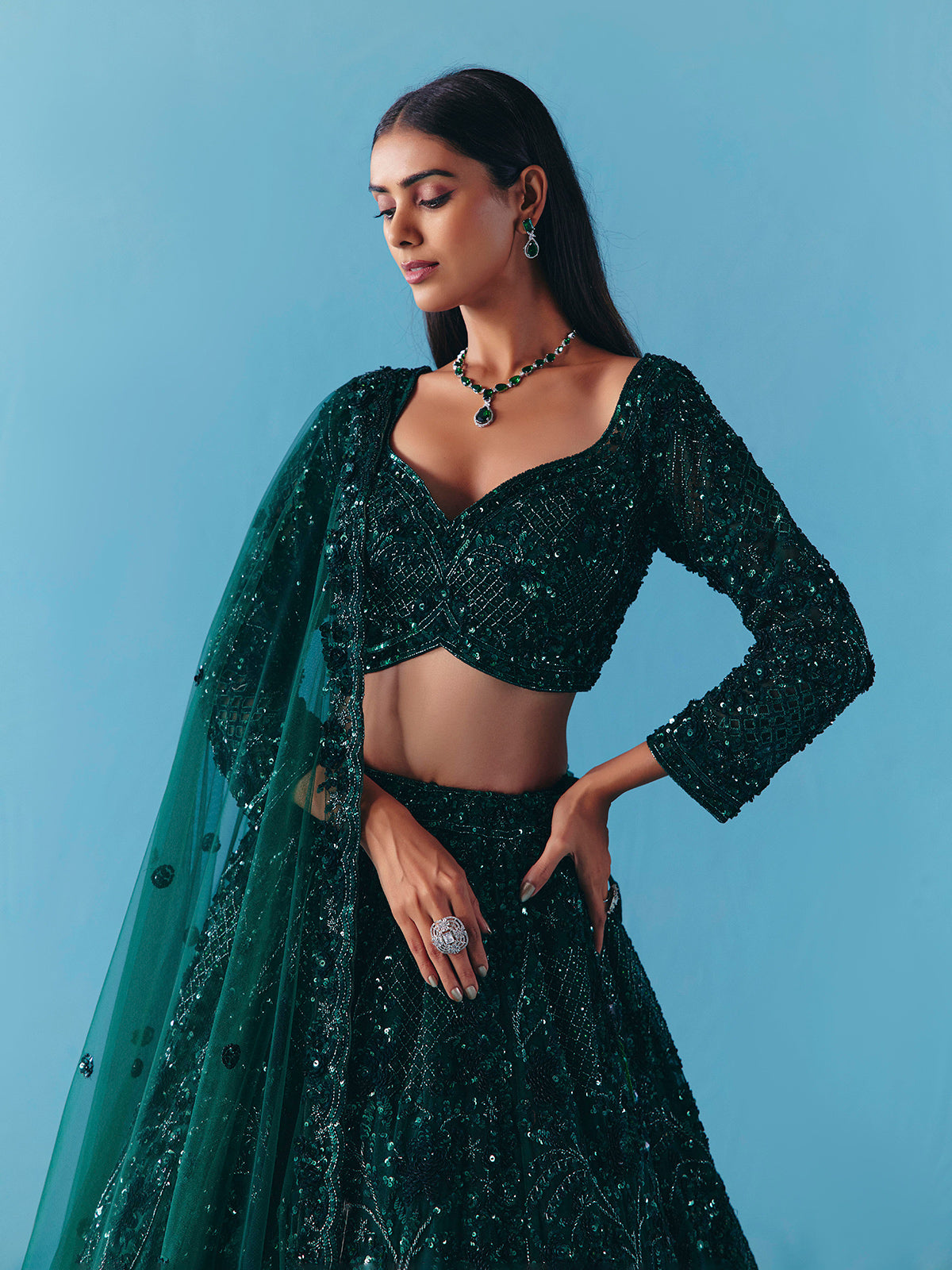 Dark green net lehenga choli with stone and sequins detail