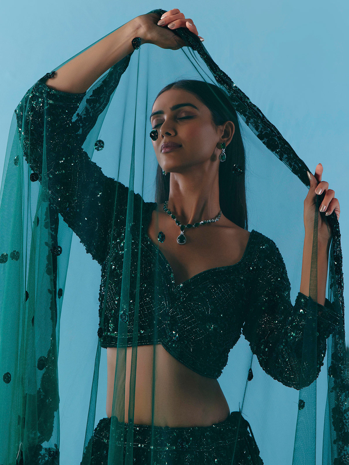 Dark green net lehenga choli with stone and sequins detail