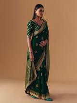 Dark green silk saree with heavy work blouse
