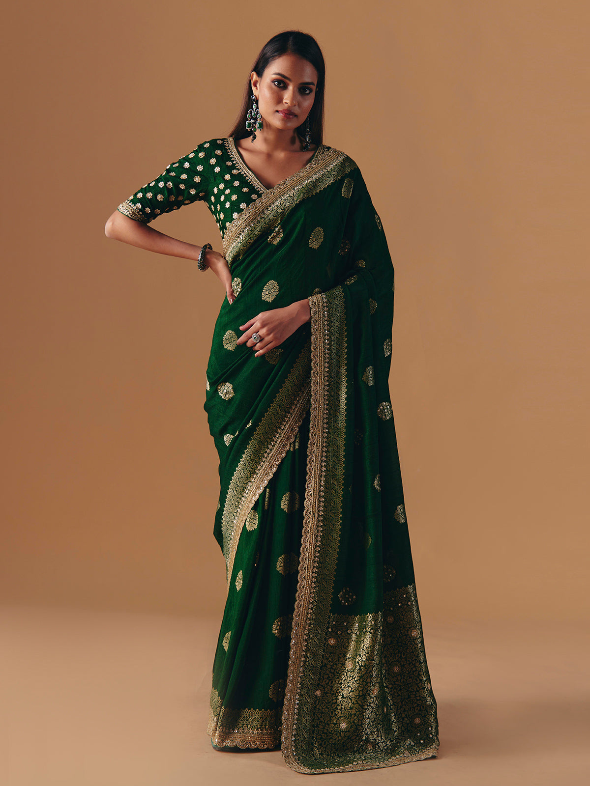 Dark green silk saree with heavy work blouse