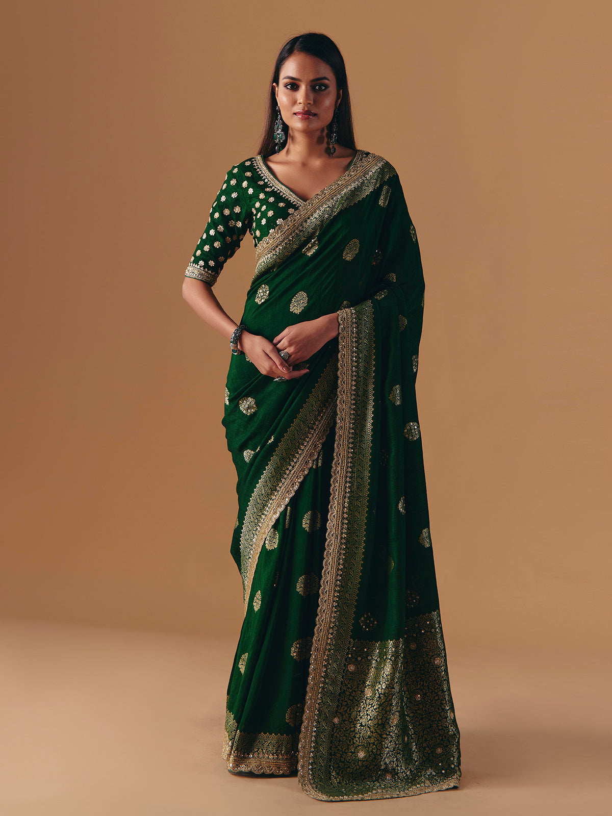 Dark green silk saree with heavy work blouse