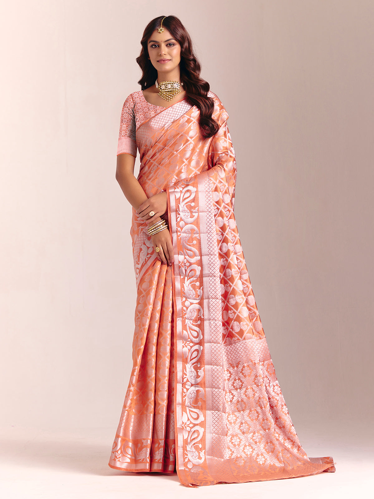 Peach silk saree accented with classic zari work