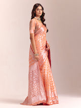 Peach silk saree accented with classic zari work