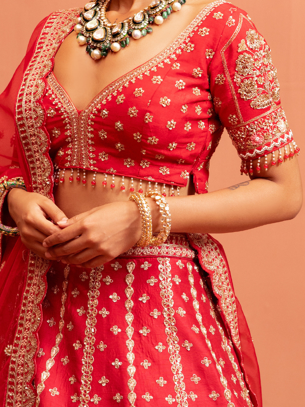 Red bridal lehenga choli with elbow sleeve blouse