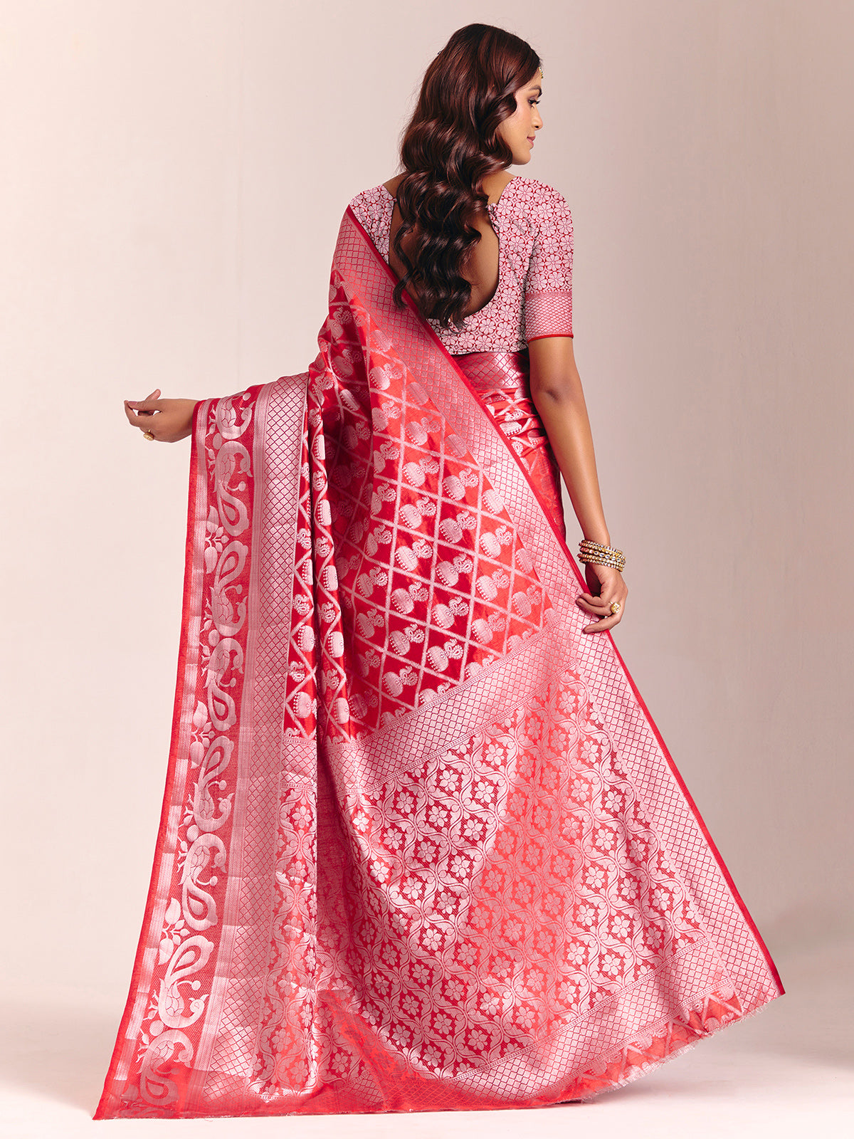 Red silk saree adorned with traditional zari detailing