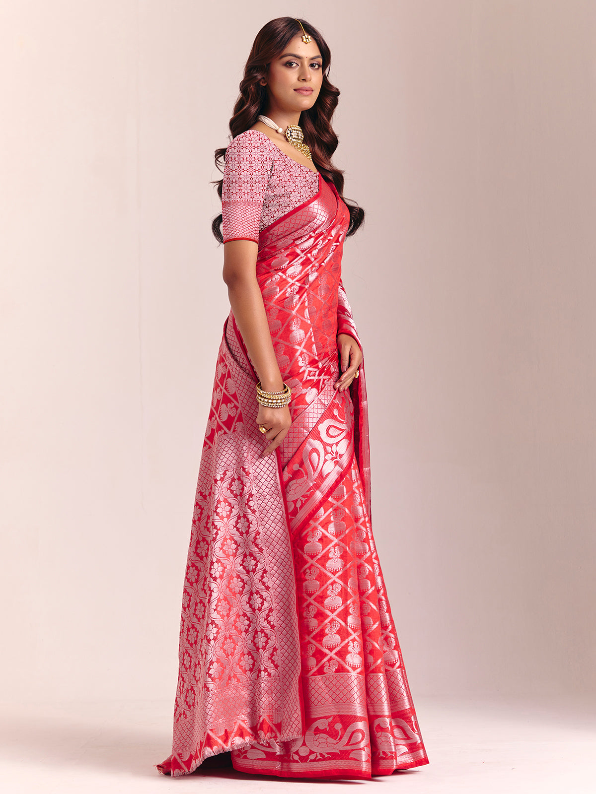 Red silk saree adorned with traditional zari detailing