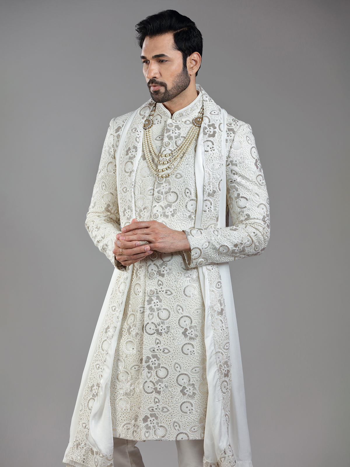 Royal splendor in cream silk with intricate embellishments and rich detailing