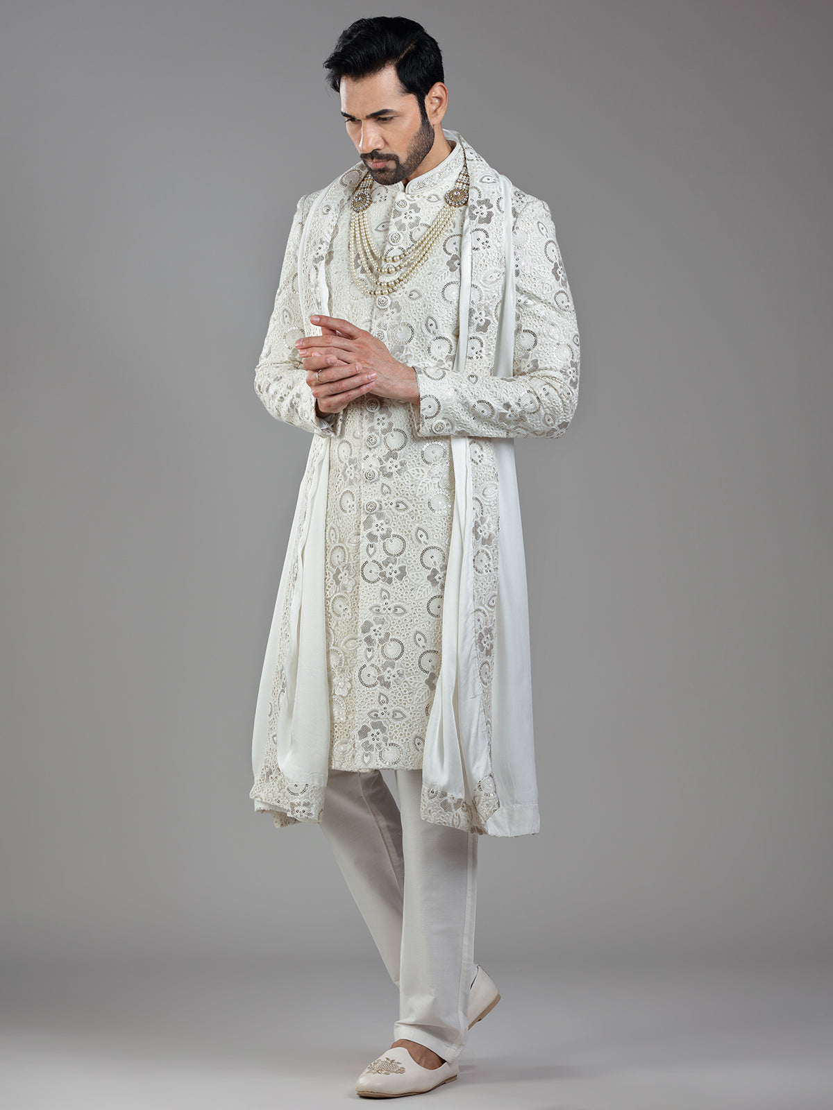 Royal splendor in cream silk with intricate embellishments and rich detailing