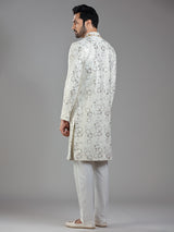 Royal splendor in cream silk with intricate embellishments and rich detailing