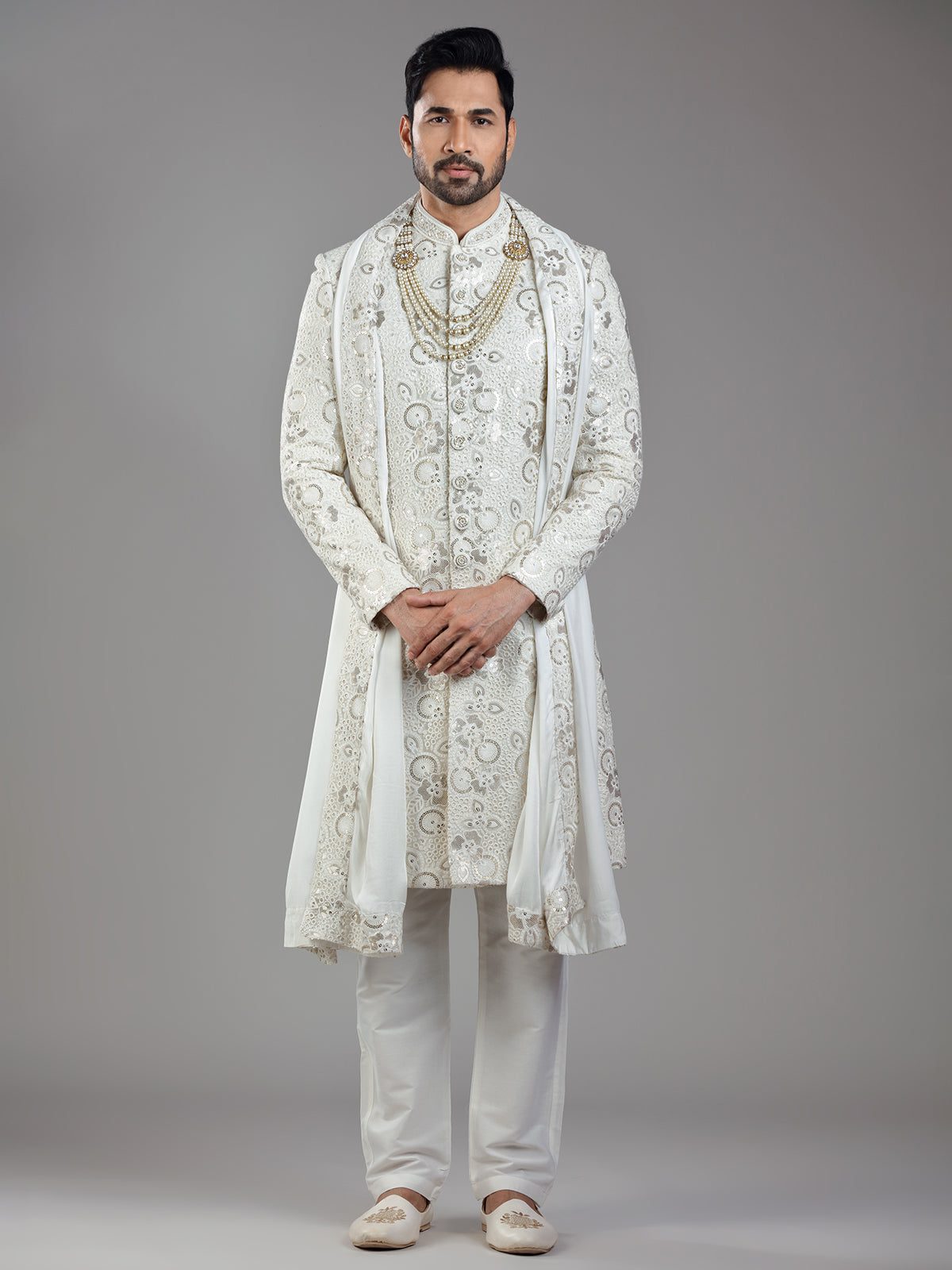 Royal splendor in cream silk with intricate embellishments and rich detailing