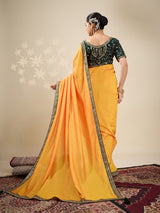 Yellow plain silk saree with green blouse
